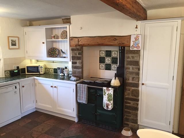 After. The resprayed kitchen in Farrow and Ball’s Wevet colour.